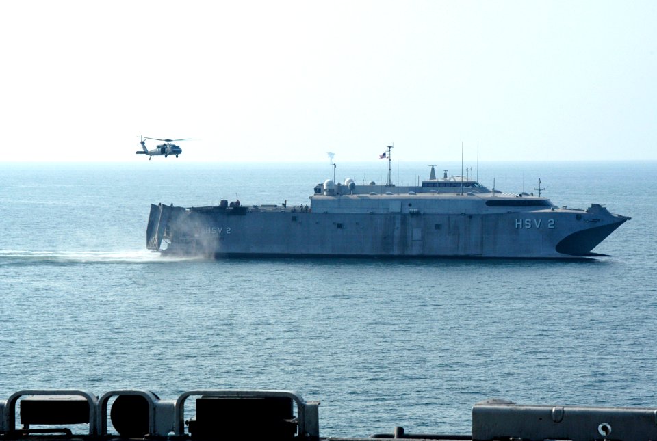 US Navy 050901-N-8154G-113 An MH-60S Seahawk helicopter prepares to pick up pallets of supplies from The U.S. Navy High Speed Vessel (HSV-2) Swift during a vertical replenishment