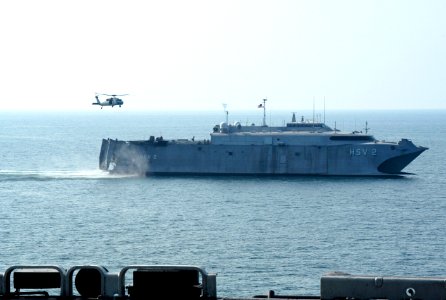 US Navy 050901-N-8154G-113 An MH-60S Seahawk helicopter prepares to pick up pallets of supplies from The U.S. Navy High Speed Vessel (HSV-2) Swift during a vertical replenishment