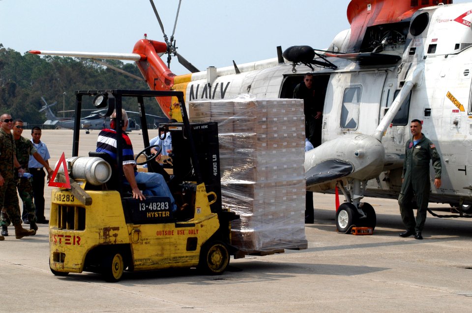 US Navy 050901-N-0438A-053 Sailors stationed on board Naval Air Station Pensacola load supplies on a UH-3H helicopter before it is transported to New Orleans to aide in disaster relief efforts for the Hurricane Katrina victims