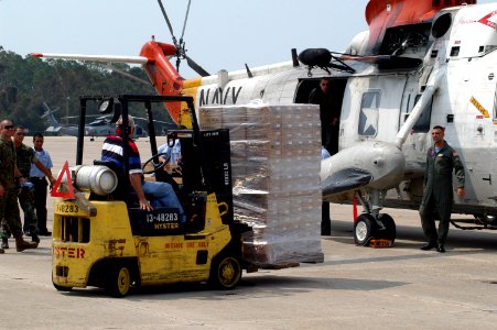 US Navy 050901-N-0438A-053 Sailors stationed on board Naval Air Station Pensacola load supplies on a UH-3H helicopter before it is transported to New Orleans to aide in disaster relief efforts for the Hurricane Katrina victims
