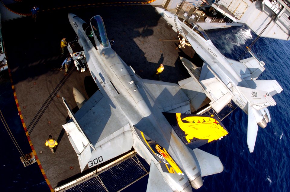 US Navy 050809-N-3488C-096 Air Department personnel secure an F-A-18C Hornet on a deck-edge elevator aboard USS Kitty Hawk (CV 63)