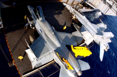 US Navy 050809-N-3488C-096 Air Department personnel secure an F-A-18C Hornet on a deck-edge elevator aboard USS Kitty Hawk (CV 63)