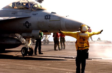 US Navy 050910-N-1416P-027 Aviation Boatswain's Mate Airman Danielle Maniscalo directs an F-A-18F Super Hornet on the flight deck aboard the nuclear-powered aircraft carrier USS Nimitz (CVN 68)