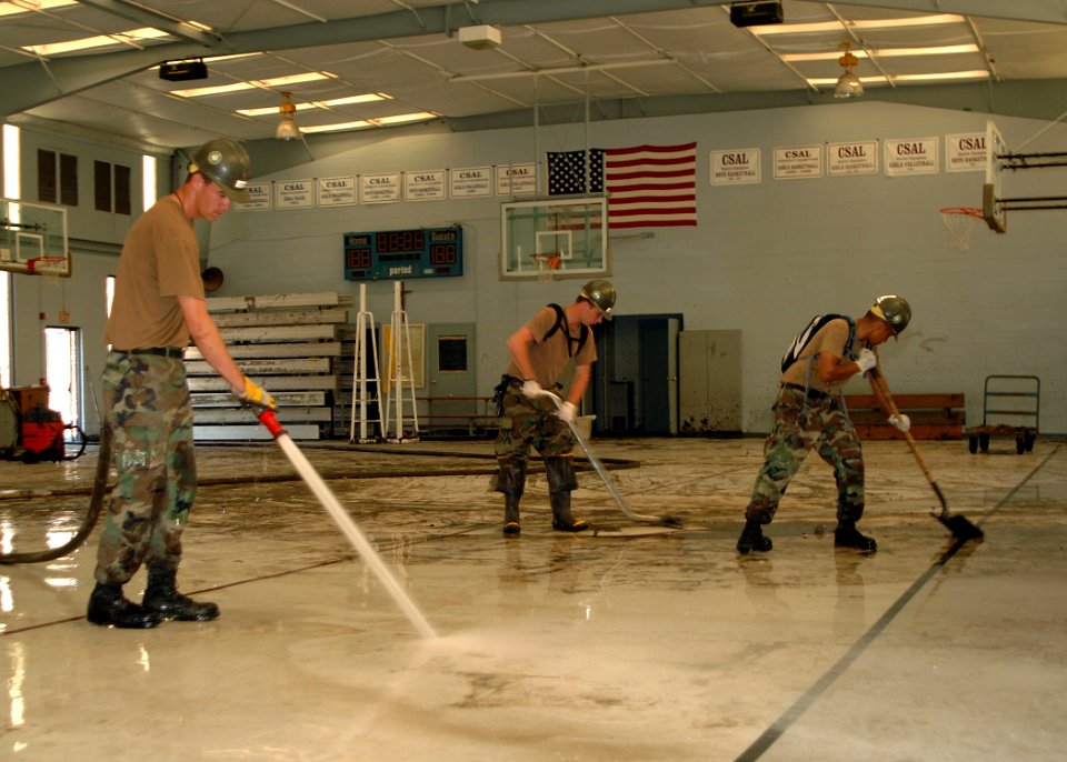 US Navy 050911-N-4374S-005 U.S. Navy Seabees, assigned to Naval Mobile Construction Battalion Four (NMCB-4), remove debris at Our Lady of Lourdes Catholic School's gymnasium in Slidell, Louisiana