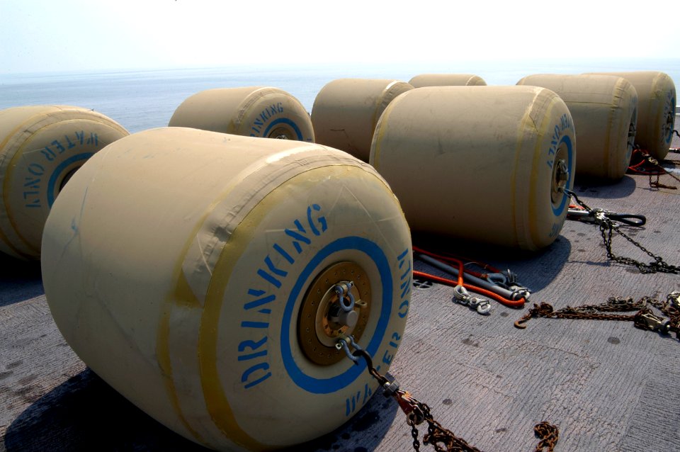 US Navy 050903-N-8154G-244 Eight rubber bladders, each holding 500 gallons of fresh drinking water, wait for transport on the flight deck of the amphibious assault ship USS Bataan (LHD 5)