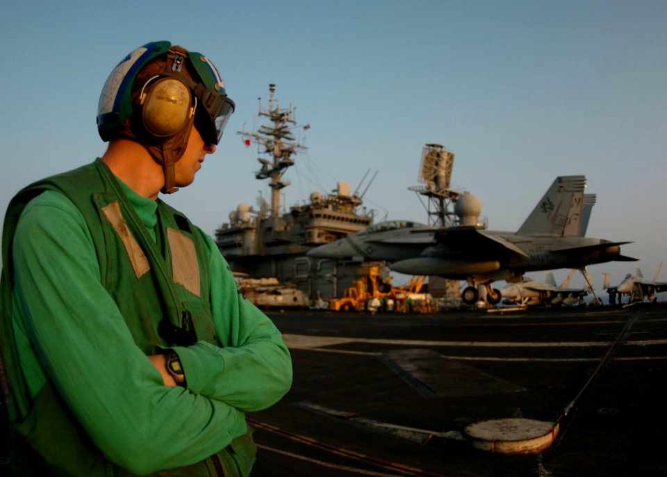 US Navy 050810-N-3488C-021 Photographer's Mate 3rd Class Adam Cobb, watches a F-A-18F Super Hornet assigned to Strike Fighter Squadron One Zero Two (VFA-102), land