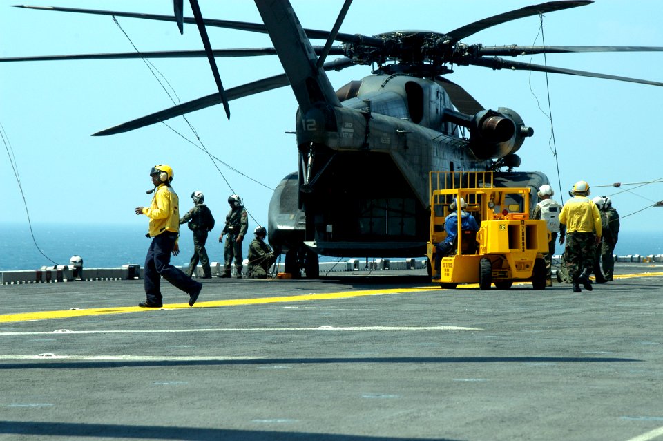 US Navy 050829-N-8154G-082 Crew members assigned to the Blackhawks of Helicopter Mine Countermeasures Squadron Fifteen (HM-15), stationed at Naval Air Station Corpus Christi, Texas, prepare to unload personnel and equipment