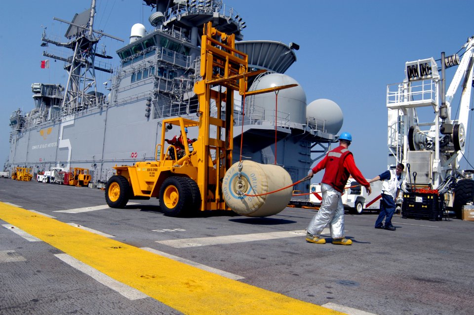 US Navy 050903-N-8154G-040 Crash and Salvage crew members aboard amphibious assault ship USS Bataan (LHD 5) move a 500 gallon rubber bladder filled with fresh drinking water for Hurricane Katrina relief efforts