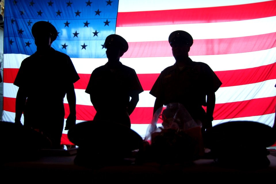 US Navy 050916-N-4772B-007 Chief petty officers (CPOs) stand behind the combination covers of the CPO selectees before the pinning ceremony in the well deck of the amphibious dock landing ship USS Harpers Ferry (LSD 49)