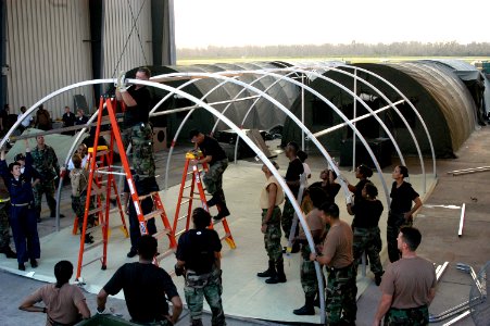 US Navy 050905-N-8154G-103 U.S. Navy personnel assigned to Casualty Receiving and Treatment Ship Team Eight (CRTS-8), based out of Naval Hospital Jacksonville, Florida, assist Army and Air Force Reservists as they set up a fiel photo