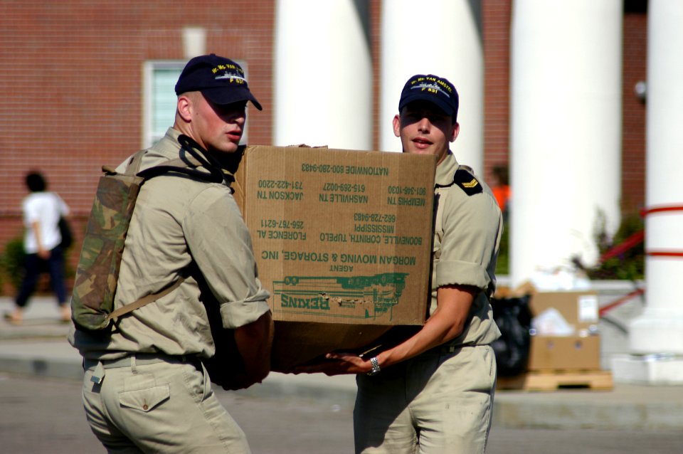 US Navy 050908-N-8154G-024 Dutch Navy Sailors assigned to the frigate Van Amstel (F 831), lend a helping hand by carrying a box of household goods to a Hurricane Katrina survivor's vehicle