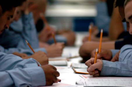 US Navy 050908-N-9866B-005 Third class petty officers, assigned to the amphibious assault ship USS Peleliu (LHA 5), concentrate during their E-5 Second Class Petty Officer examination on the mess decks aboard ship