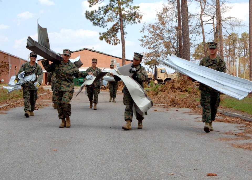 US Navy 050909-N-4374S-003 U.S. Marines, assigned to the Marines Expeditionary Unit Service Support Group One One (MSSG-11), remove debris at D'iberville Elementary School in support of Hurricane Katrina relief efforts
