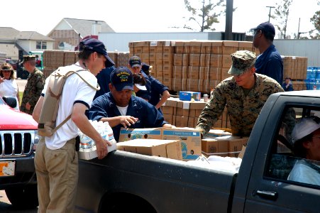 US Navy 050908-N-8154G-051 U.S. Navy Sailors assigned to the amphibious assault ship USS Bataan (LHD 5), Dutch Sailors from frigate Van Amstel (F 831) and U.S. Marines load cases of bottled water and Meals Ready-to-Eat (MRE)