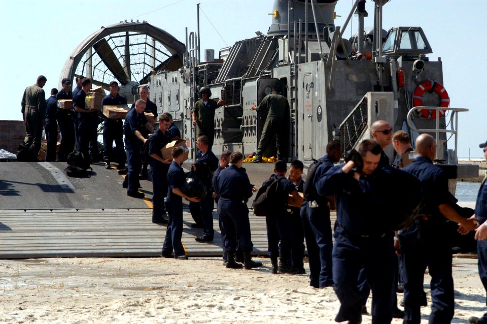 US Navy 050909-N-0793G-004 U.S. Navy Sailors assigned to the amphibious dock landing ship USS Whidbey Island (LSD 41) unload supplies brought ashore by a Landing Craft, Air Cushion (LCAC)