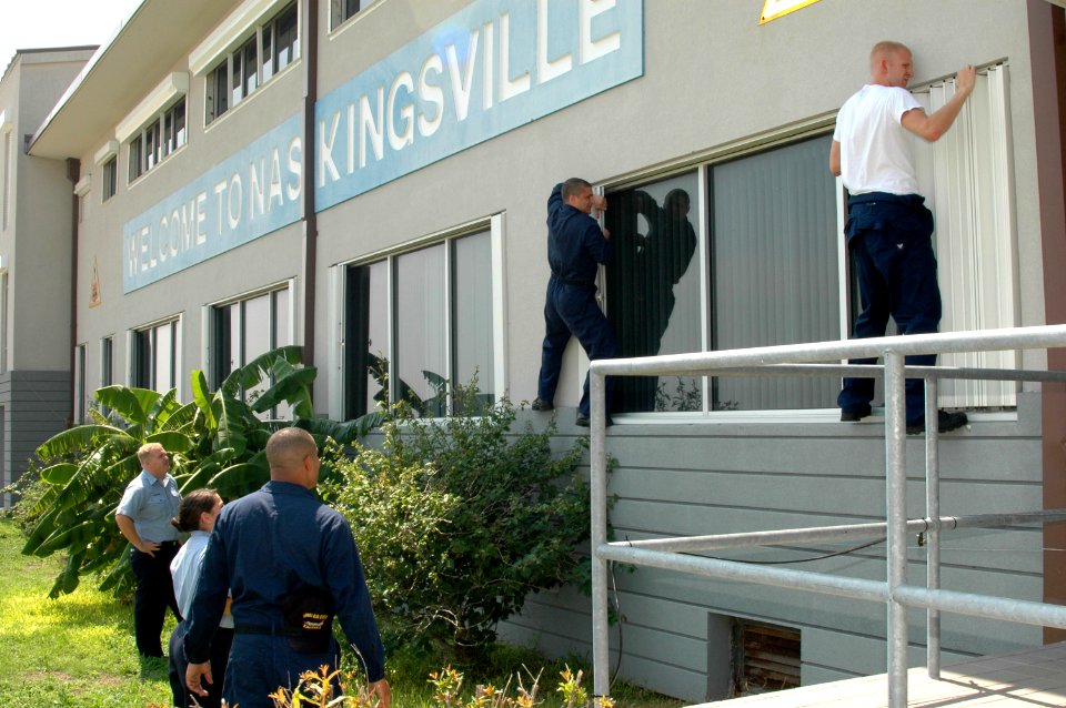 US Navy 050921-N-0000X-001 Sailors assigned to Air Operations on board Naval Air Station Kingsville, Texas, board-up windows on the Air Operations building prior to the arrival of Hurricane Rita