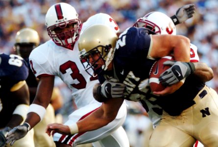 US Navy 050910-N-9693M-002 U.S. Naval Academy Midshipmen fullback Adam Ballard is tackled by Stanford Cardinal linebacker Michael Okwo