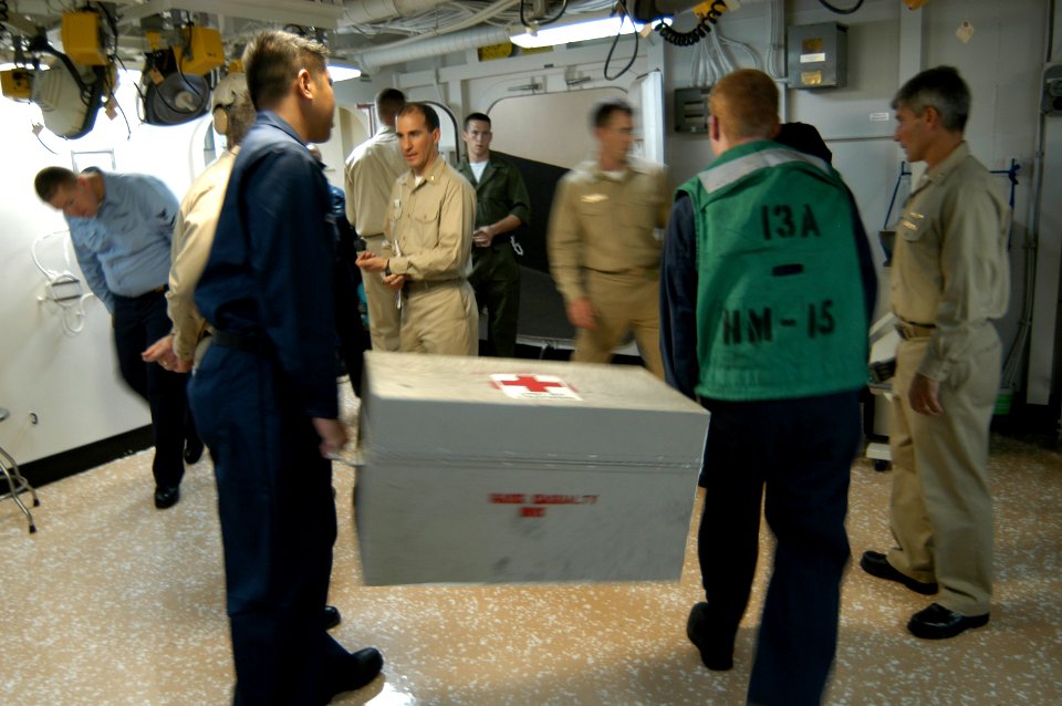 US Navy 050903-N-8154G-160 Crew members aboard amphibious assault ship USS Bataan (LHD 5) transport medical supplies to the flight deck for loading on a helicopter