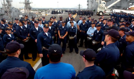 US Navy 050909-N-9866B-012 Intelligence Specialist 1st Class Lance Howell, center, musters Operations Department Sailors at their lifeboat station during an abandon ship drill