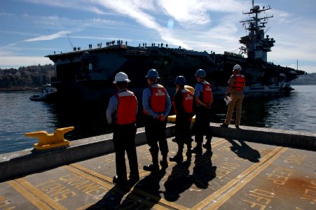 US Navy 050926-N-3390M-029 Line handlers standby as the Nimitz-class aircraft carrier USS Abraham Lincoln (CVN 72) prepares to dock at her homeport of Naval Station Everett, Wash photo