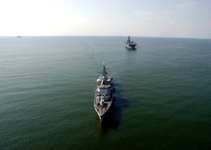 US Navy 050909-N-8154G-220 The amphibious assault ship USS Bataan (LHD 5), background, sits anchored off the Mississippi coast, along with the Dutch frigate HMS Van Amstel (F-831)