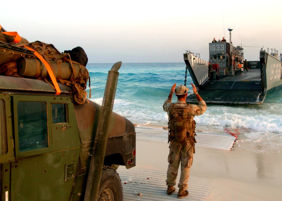 US Navy 050928-N-0716S-032 U.S. Navy Gunner's Mate 2nd Class Daniel Graves, assigned to Beach Masters Unit One (BMU-1), guides a Landing Craft, Utility onto an Egyptian beach