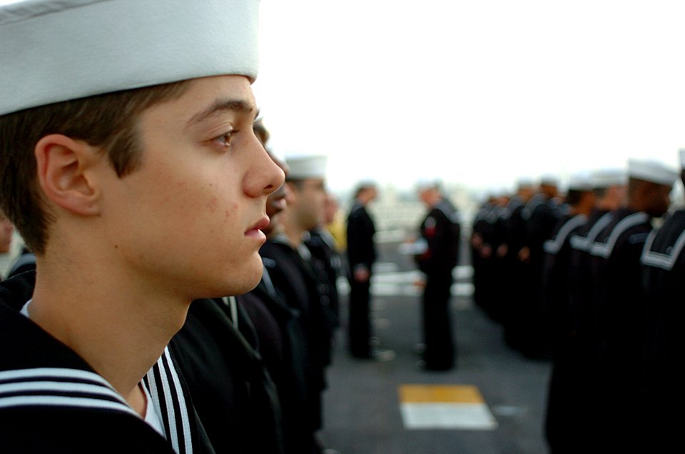 US Navy 051003-N-9866B-002 A Sailor waits for his time to be evaluated during a Service Dress Blues uniform inspection on the flight deck of the amphibious assault ship USS Peleliu (LHA 5)