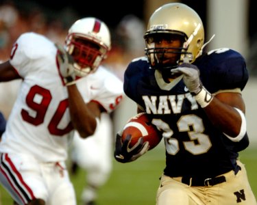 US Navy 050910-N-9693M-005 U.S. Naval Academy Midshipmen slotback Karlos Whittacker outpaces Stanford Cardinal linebacker Udeme Udofia to score in the 2nd quarter