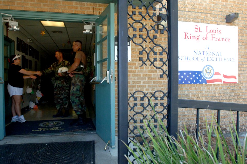 US Navy 050928-N-2653P-048 Naval Mobile Construction Battalion Four Zero (NMCB-40) Operations Officer Lt. Cmdr. Christopher Adams meets Saint Louis King of France Catholic School Principal