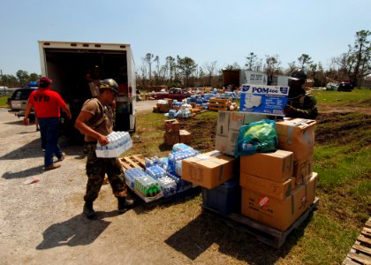 US Navy 050908-N-4374S-009 U.S. Navy Seabees assigned to Naval Mobile Construction Battalion Seven (NMCB-7), distribute relief supplies to the residents of Harrison County