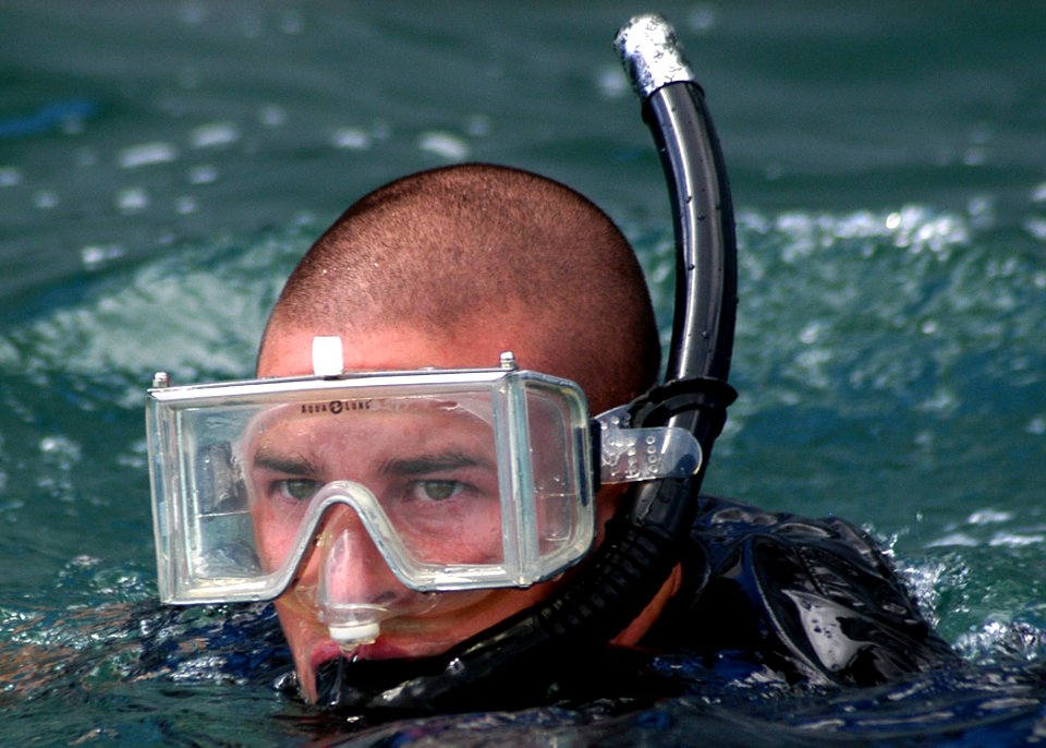 US Navy 050913-N-3019M-010 Damage Controlman 2nd Class Luke Warner, assigned to the guided missile destroyer USS Chung-Hoon (DDG 93), simulates a swimmer attack scenario during an anti-terrorism-force protection exercise