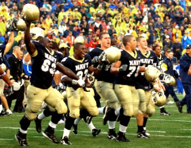 US Navy 051008-N-9693M-022 Members of the U.S. Naval Academy football team run across the field toward the home team stands in celebration of their victory over Air Force 27-24 at Navy-Marine Corps stadium