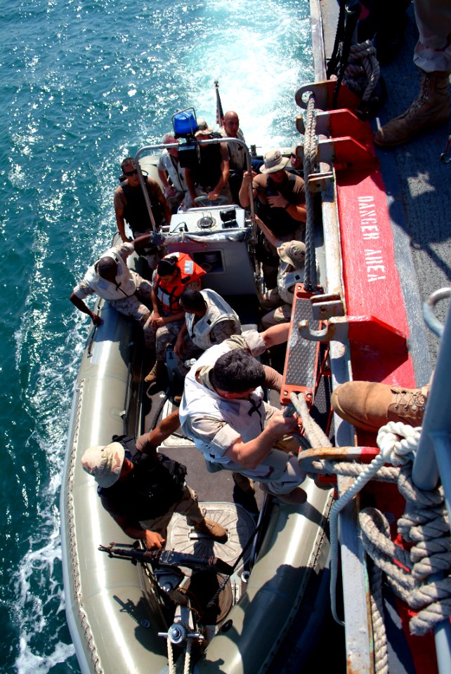 US Navy 051013-N-0962S-048 Master Chief Petty Officer of the Navy (MCPON) Terry Scott climbs down an accommodation ladder to a Rigid Hull Inflatable Boat (RHIB) from the guided missile cruiser USS Chosin (CG 65)
