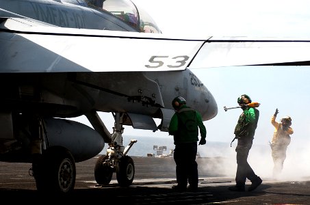 US Navy 050919-N-7130B-074 Flight deck personnel prepare an F-A-18B Hornet, assigned to the Sharp Shooters of Marine Fighter Attack Training Squadron One Zero One (VMFAT-101), for launch