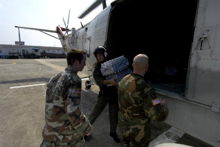 US Navy 050902-N-5328N-444 Military personnel unload cases of water near the Superdome in New Orleans, from an U.S. Navy UH-3H Sea King helicopter in New Orleans
