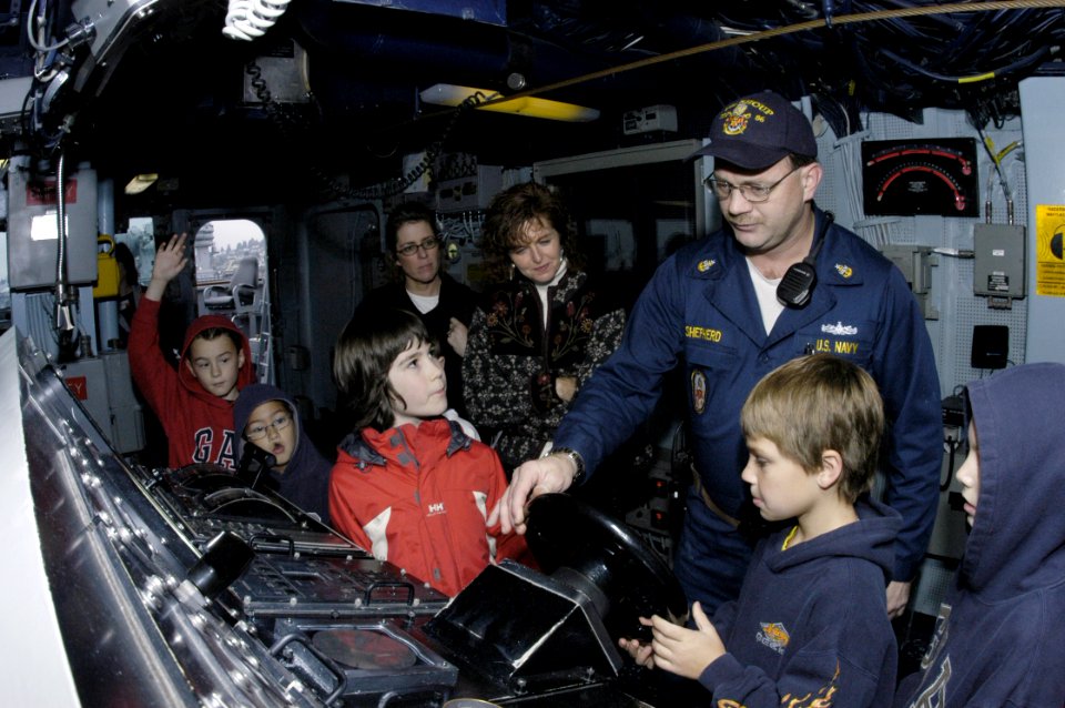 US Navy 051013-N-6477M-130 Children from the Fairmount Elementary School in Mukilteo, Wash., learn how to man the helm