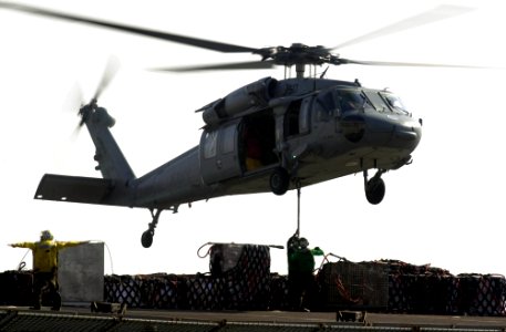 US Navy 050919-N-0361G-109 An MH-60S Seahawk helicopter prepares to drop-off pallets of cargo on the flight deck of the nuclear-powered aircraft carrier USS Nimitz (CVN 68)