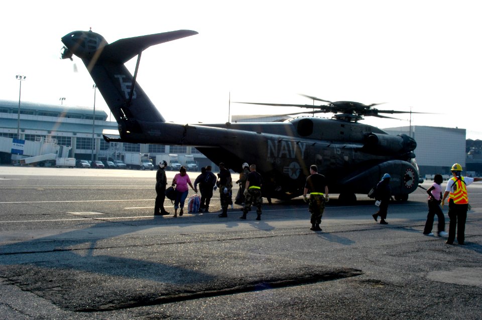US Navy 050903-N-1467R-018 U.S. Air Force personnel and U.S. Navy air crewmen direct Hurricane Katrina survivors from the back ramp of an MH-53E Sea Dragon helicopter at the New Orleans International Airport