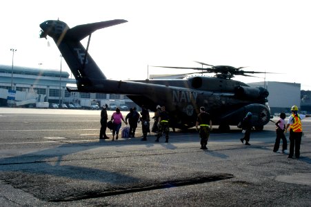 US Navy 050903-N-1467R-018 U.S. Air Force personnel and U.S. Navy air crewmen direct Hurricane Katrina survivors from the back ramp of an MH-53E Sea Dragon helicopter at the New Orleans International Airport