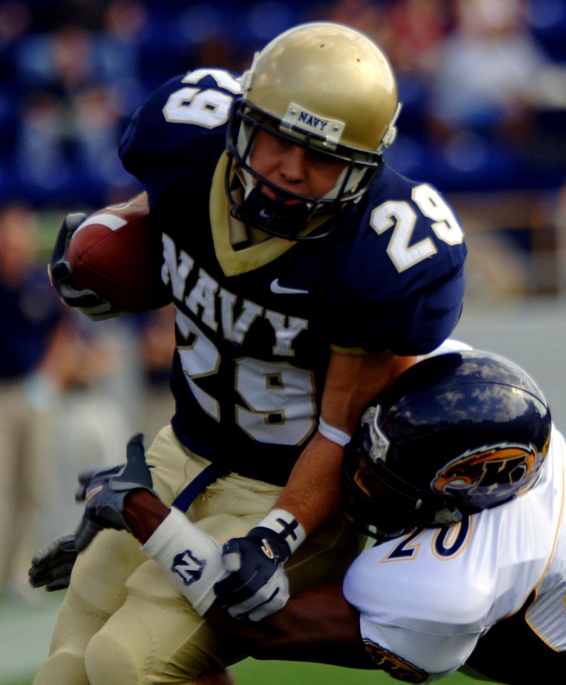 US Navy 051015-N-9693M-005 U.S. Naval Academy Midshipman slot back Marco Nelson is tackled by Kent State Golden Flashes defender Dennis Pittman