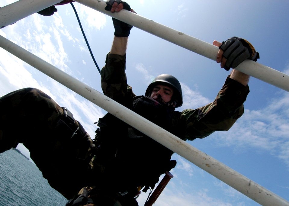 US Navy 050923-N-3019M-009 A Sailor assigned to the guided missile cruiser USS Cowpens (CG 63) boards the ex-U.S. Coast Guard Cutter Yacona as part of a visit, board, search and seizure (VBSS)