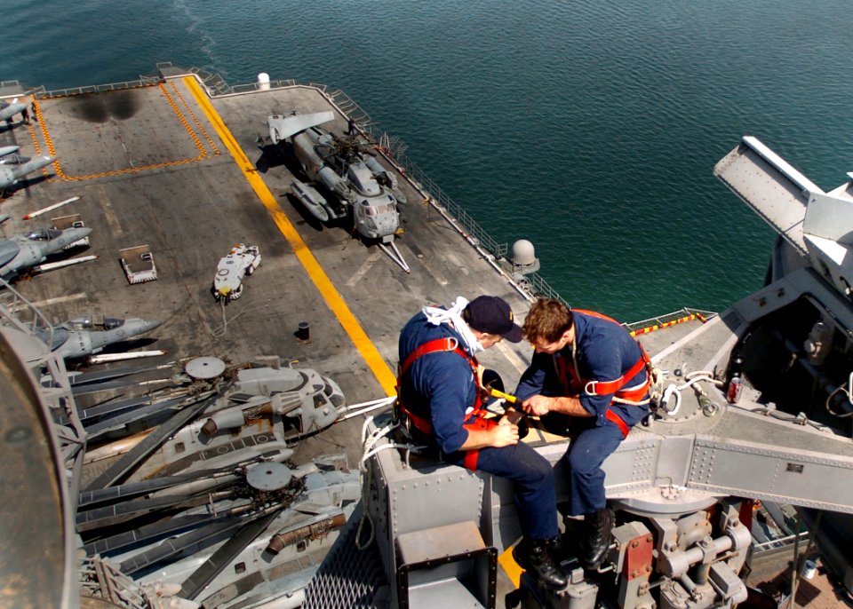 US Navy 051001-N-0716S-002 Electronics Technician 3rd Class Adrian Estrada and Electronics Technician 3rd Class Dustin Felton work aloft