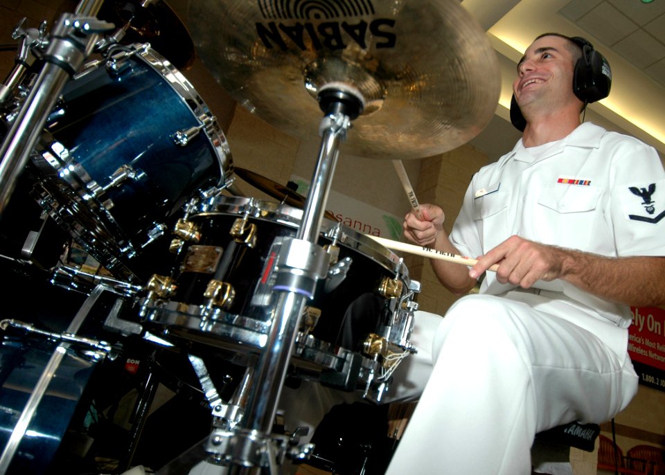 US Navy 050925-N-3019M-002 Musician 3rd Class Ross Hartig, assigned to the Pacific Fleet Rock Band on Pearl Harbor, plays the drums during a public concert