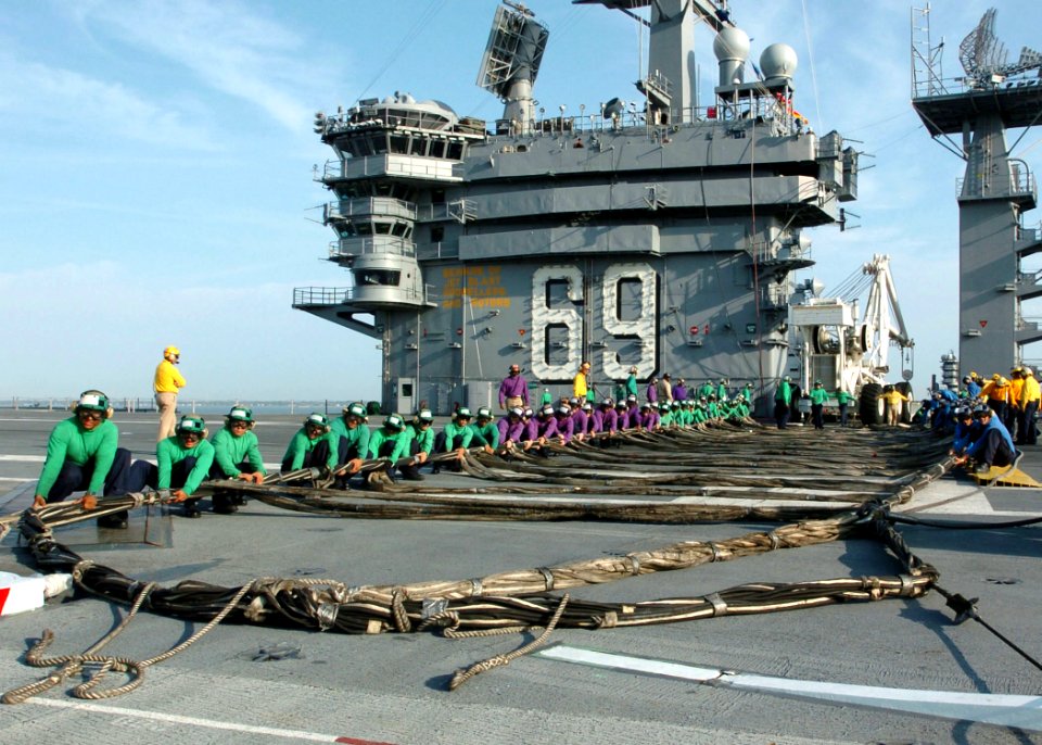 US Navy 050926-N-7359L-001 Air Department personnel assigned to the Nimitz-class aircraft carrier USS Dwight D. Eisenhower (CVN 69), assemble the emergency-landing barricade net on the flight deck during a training drill in por