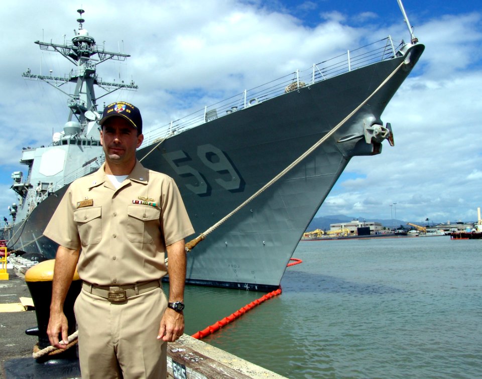 US Navy 050928-N-9643K-001 USS Russell (DDG 59) Commanding Officer Cmdr. James W. Kilby stands in front of his ship, after returning from a two-month deployment participating in the Alaska Shield-Northern Edge 2005