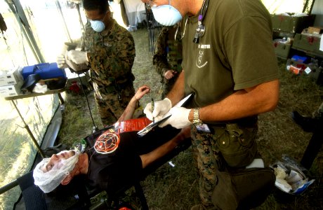 US Navy 050919-F-5789F-163 U.S. Navy medical technicians assess an injured civilian during a simulated man-made disaster