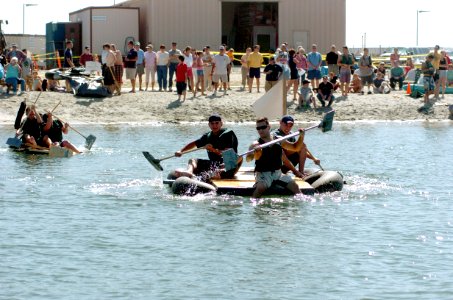US Navy 050924-N-6843I-215 Teams participating in the Bayside Boat Bash race their vessels to a buoy 100-meters from shore photo