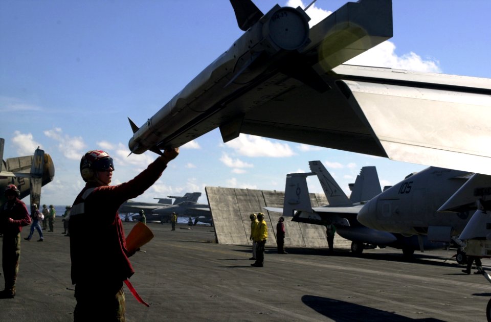 US Navy 051021-N-0361G-020 Aviation Ordnanceman Airman Clayton Hill checks an AIM-9X Sidewinder air-to-air missile loaded on the wingtip of an F-A-18E Super Hornet