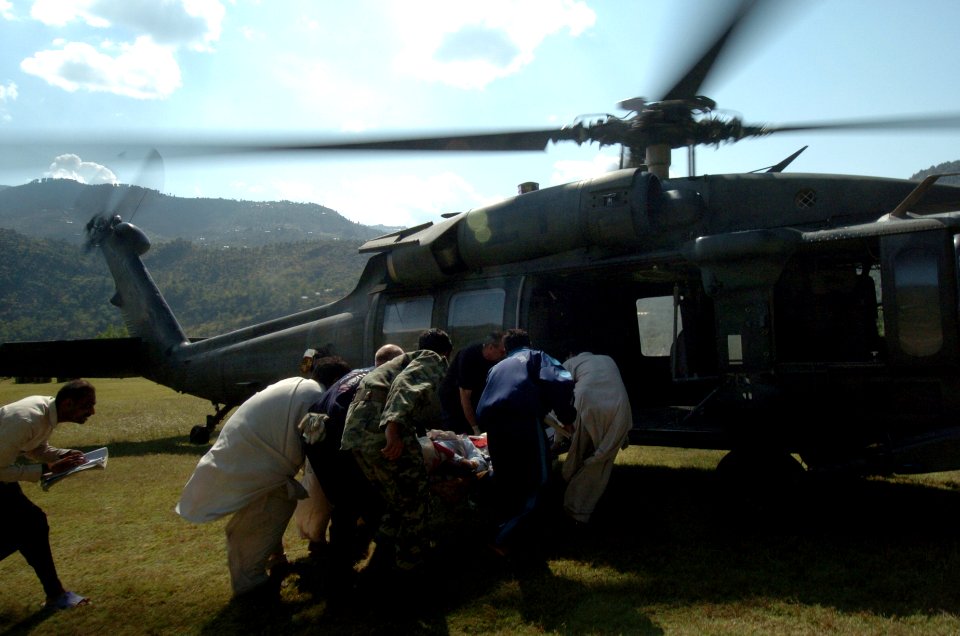 US Navy 051012-N-8796S-114 Members of the Pakistan military and civilians from multinational relief agencies carry an injured woman to a U.S. Army UH-60 Blackhawk helicopter for a medical evacuation in the remote Pakistani vill