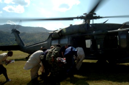US Navy 051012-N-8796S-114 Members of the Pakistan military and civilians from multinational relief agencies carry an injured woman to a U.S. Army UH-60 Blackhawk helicopter for a medical evacuation in the remote Pakistani vill